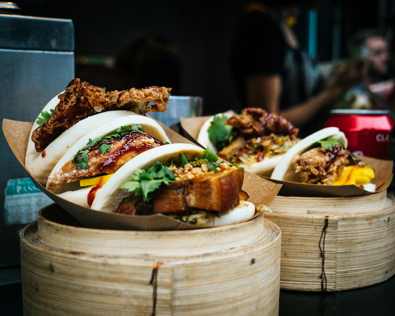 Services Tasty bao buns with meat and vegetables, captured in a vibrant street market in England.